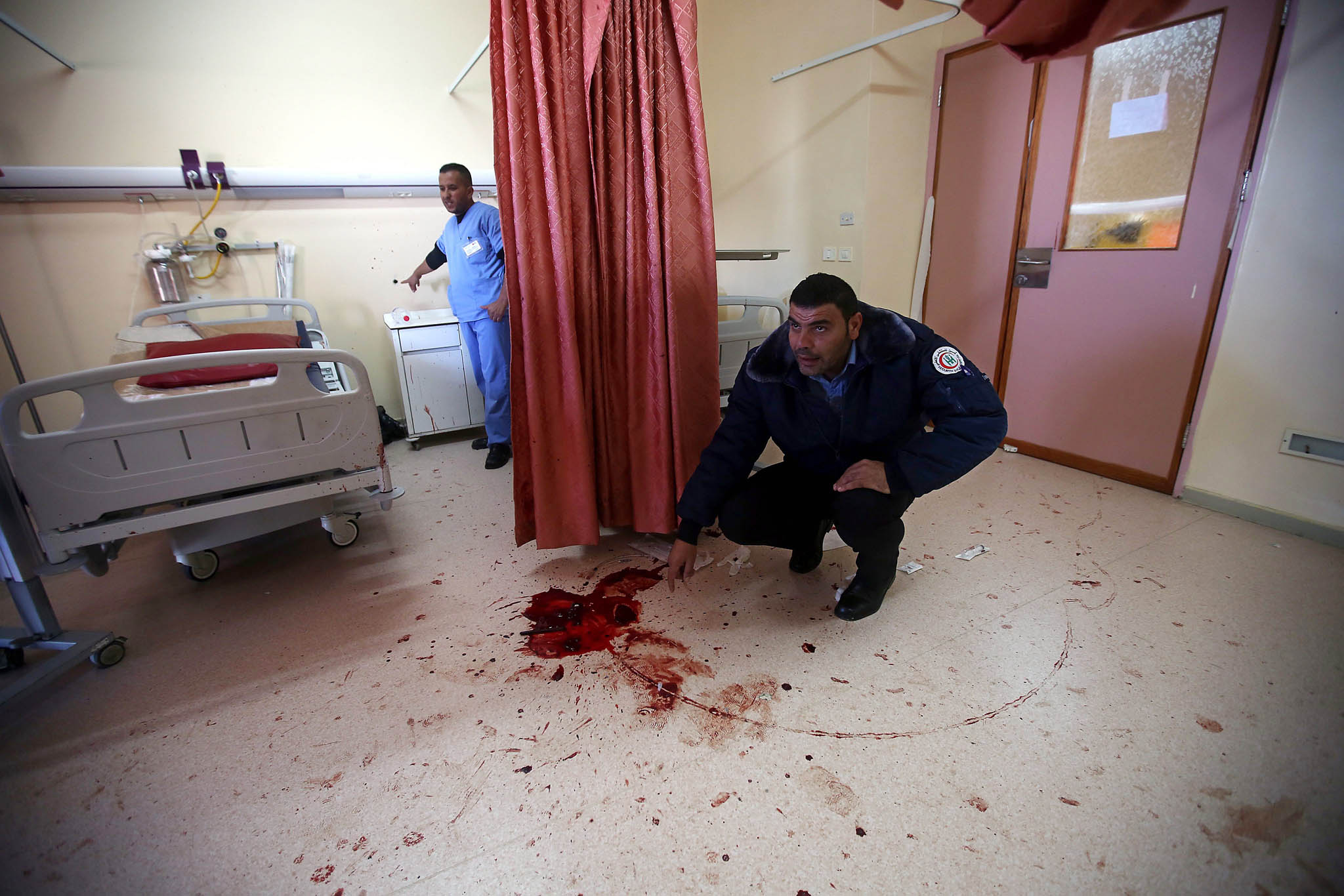 epa05021437 Palestinian hospital security checks the room where Israeli special forces killed 27 years old Abdallah Shalaldeh and arrested his cousin at the Al-Ahli hospital in the West Bank city of Hebron 12 November 2015. Shalaldeh was shot dead by Israeli special forces during a raid to arrest his cousin Azzam Shalaldeh. An undercover Israeli unit raided a southern West Bank hospital early 12 November, killing one Palestinian and seizing another, the Palestinian Health Ministry said. An Israeli military spokeswoman in Tel Aviv said that security forces had sought to apprehend a Palestinian accused of stabbing an Israeli outside a settlement bloc south of Jerusalem on 25 October 2015. The alleged Palestinian assailant, Azzam Shalaldeh, 20, had been shot by the Israeli victim. The Israeli was, in turn, severely injured with a stab wound to the chest. EPA/ABED AL HASHLAMOUN ATTENTION EDITORS PICTURE CONTAINS GRAPHIC CONTENT